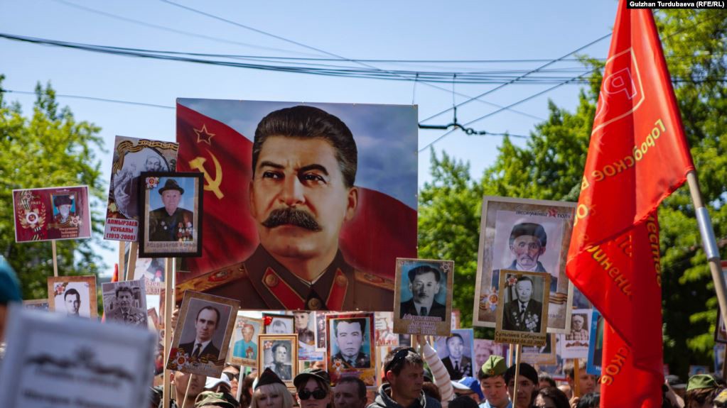 The UK Defense Intelligence Named the Real Reason For the Cancellation of the Immortal Regiment Remembrance Marches in Russia, Portrait of Stalin is traditional participant of 'Immortal Regiment' marches, The remembrance marche in Kyrgyzstan, 2019, RFE/RL, Defense Express