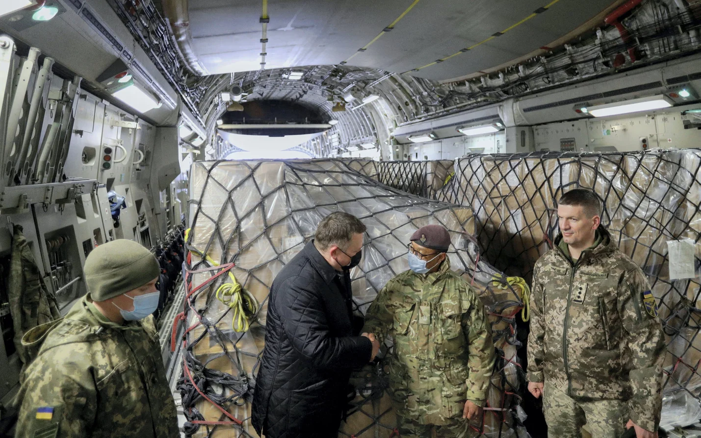 Ukrainian officials receive a shipment of Britain's military aid at Boryspil International Airport outside Kyiv, in February.Credit: Valentyn Ogirenko/Reuters
