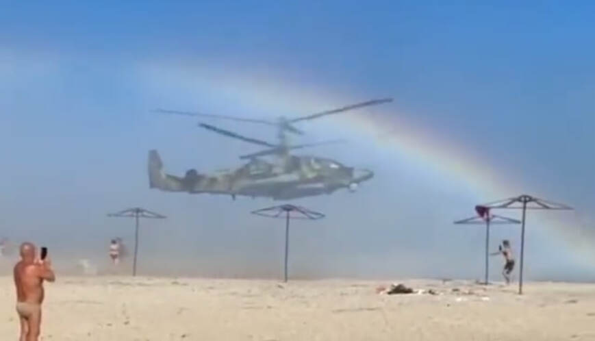 A russian Ka-52 circles over a beach in temporarily occupied Berdyansk, Defense Express