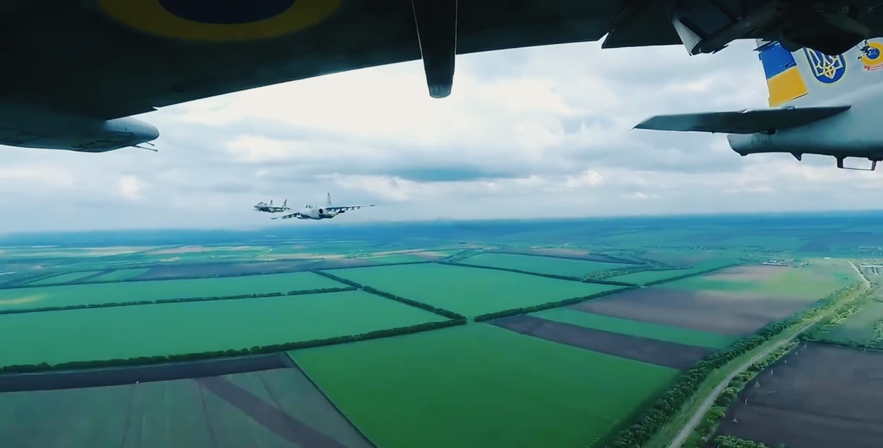 A MiG-29 escorts two Su-25 attack aircraft