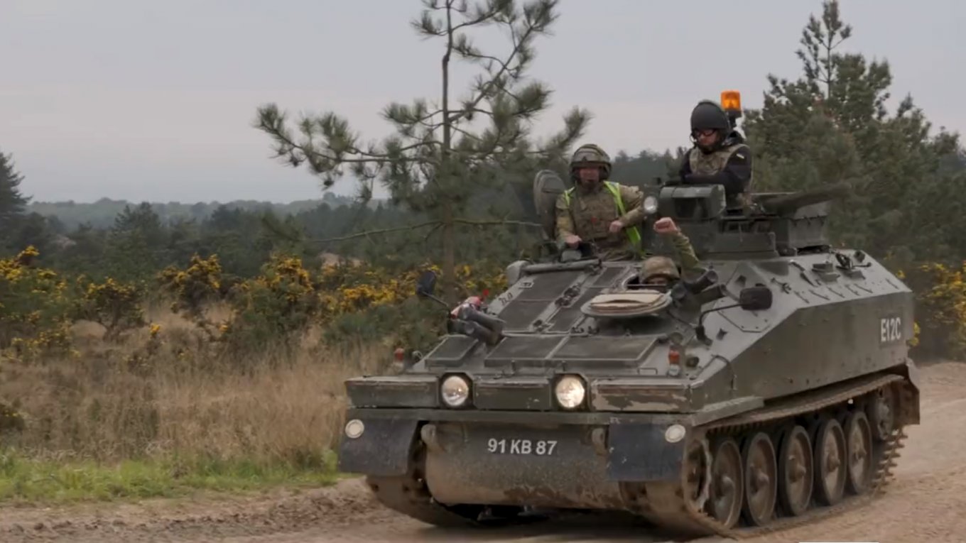 Ukrainian servicemen on a Spartan APC on a British training ground