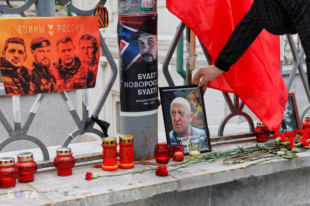 A handmade memorial featuring Prigozhin alonside other russian war criminals and propagandists