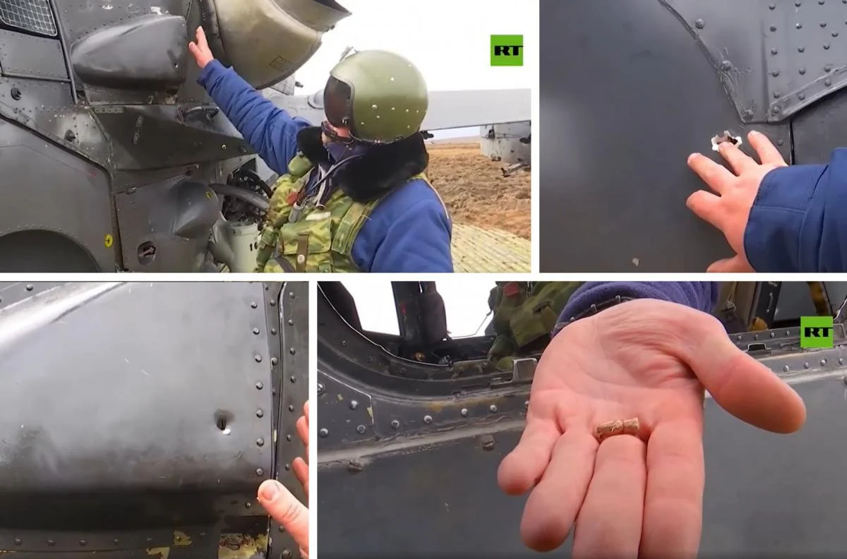 Russian Ka-52 pilot shows the damage caused to his helicopter by rifle fire from the ground