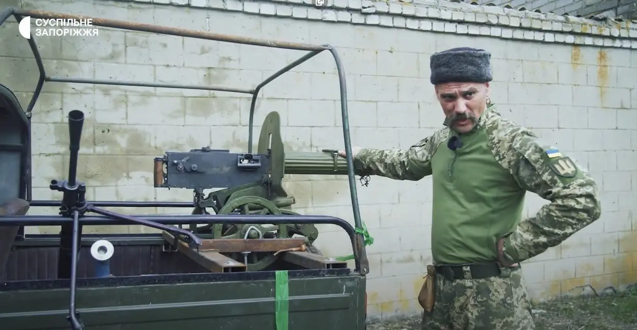 A soldier of Zaporizhzhia Territorial Defense Forces next to a pick-up with a Maxim machine gun and a Soviet DP-27, May 2022