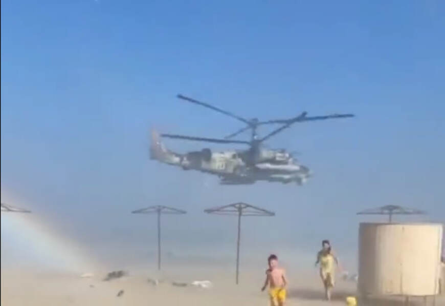 A russian Ka-52 circles over a beach in temporarily occupied Berdyansk, Defense Express