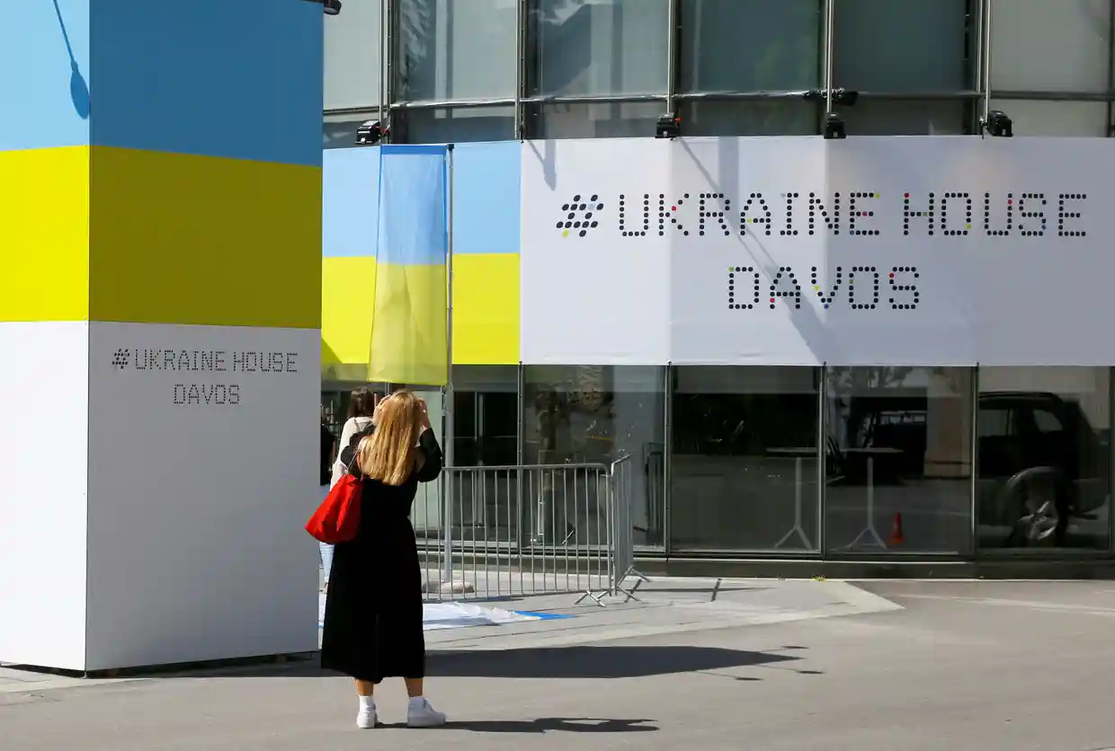 A woman stands in front of the Ukrainian House Davos, ahead of the upcoming World Economic Forum 2022, in the Alpine resort of Davos, Switzerland, Defense Express
