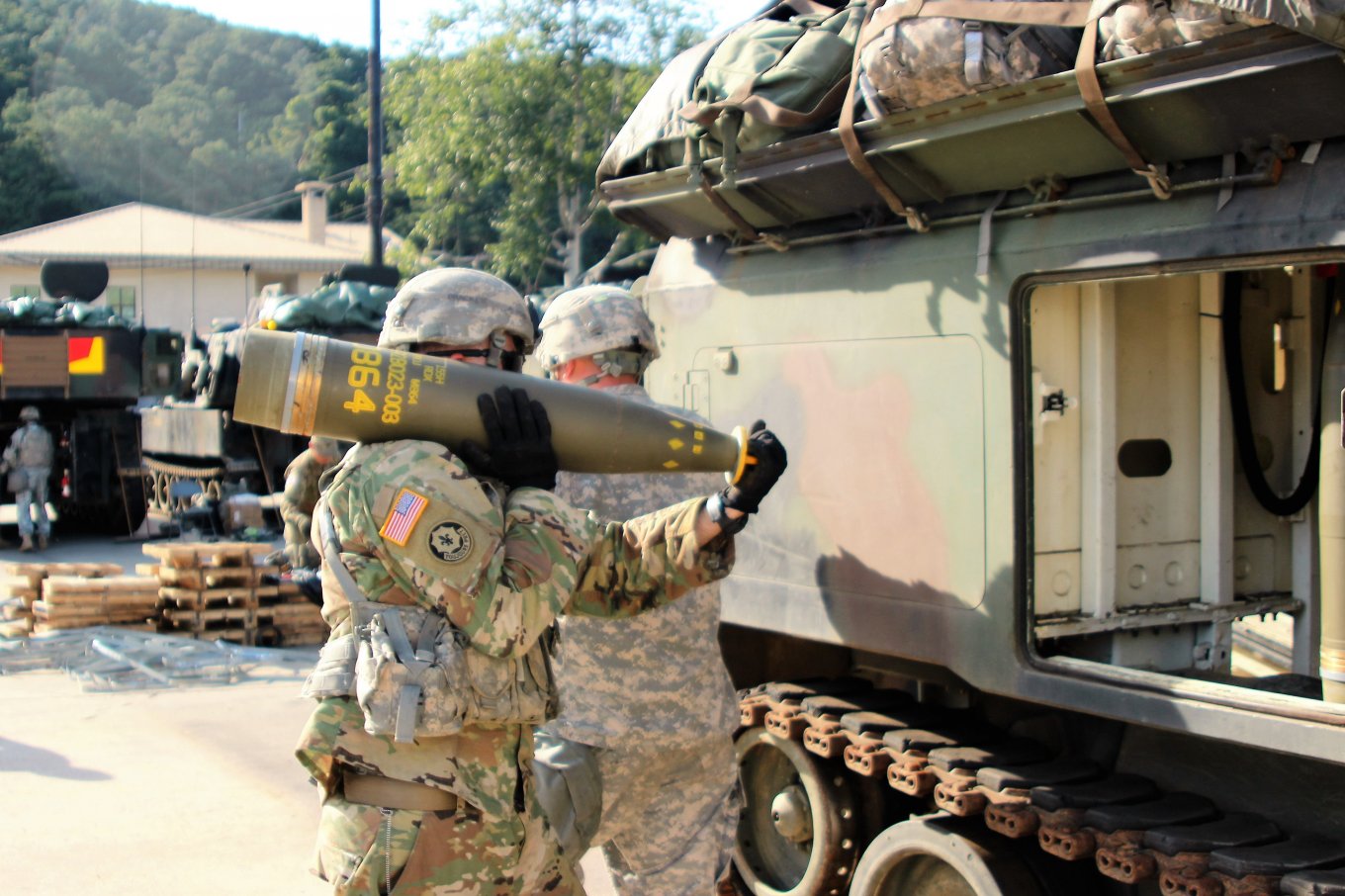 US soldier carries an M864 DPICM munition