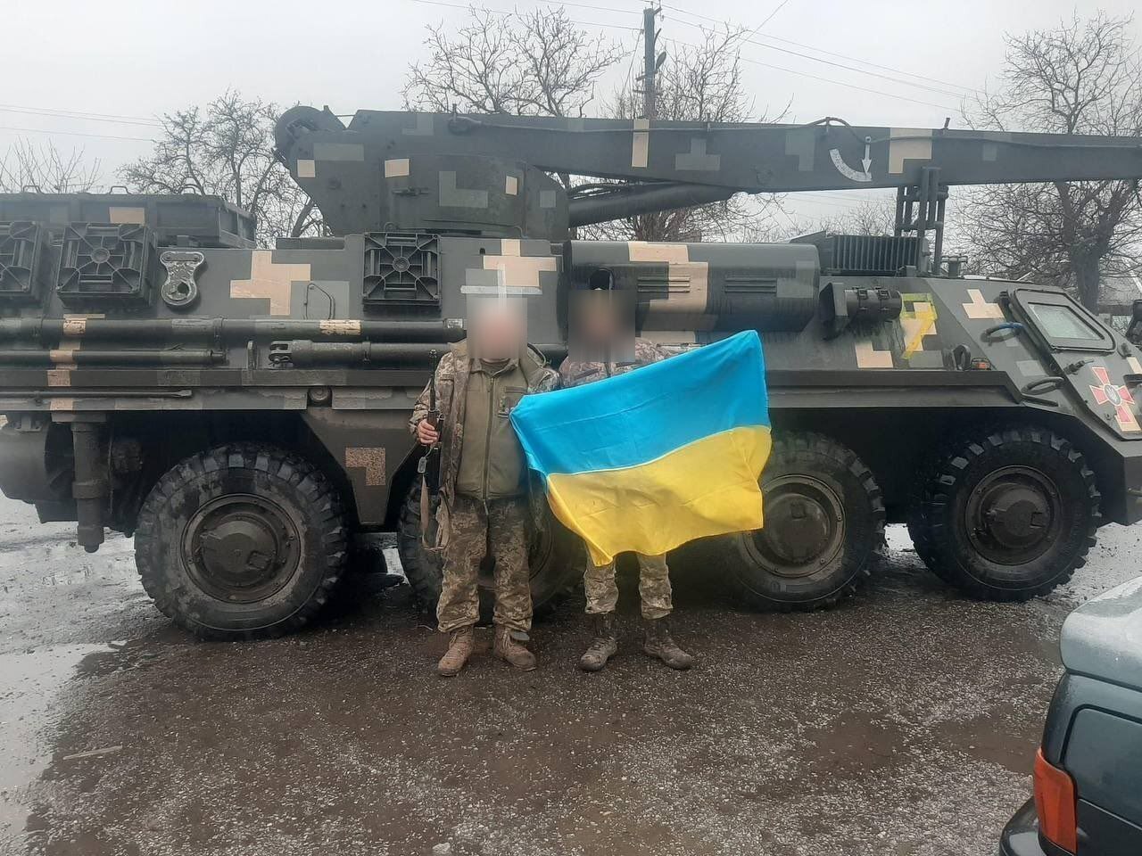 Ukrainian soldiers and a BREM-4 inthe background, spring 2023