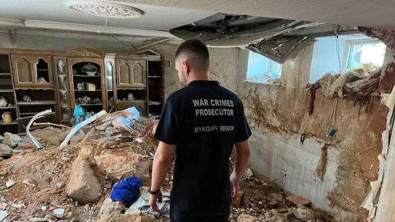 A Ukrainian war crimes prosecutor examines the damage in a destroyed building, following shelling in Mykolaiv, Ukraine, on July 31, as Russia's attack continues. (Press service of the Mykolaiv Regional Prosecutor's Office , Defense Express