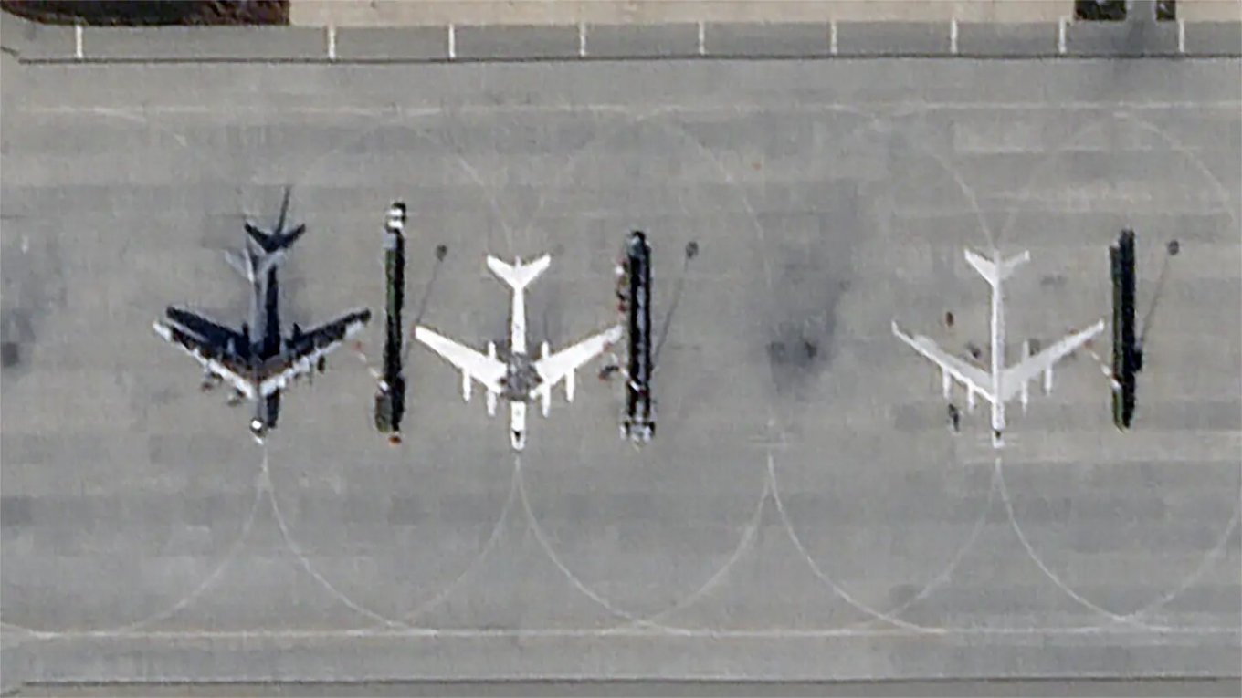 Fearing an Attack by Ukrainians, russians Painting Silhouettes of Tu-95MS Bombers at the Engels Air Base, russian Tu-95MS and false targets at Engels airfield, September 29, 2023, Defense Express