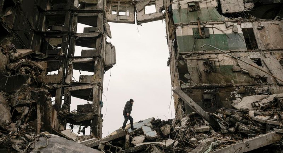 A resident looks for belongings in an apartment building destroyed during fighting between Ukrainian and Russian forces in Borodyanka, Ukraine, Tuesday, April 5, 2022, Defense Express