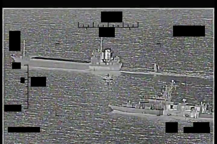 The same IRGCN Shahid Baziar towing the seized Saildrone Explorer, now shadowed by a U.S. patrol vessel