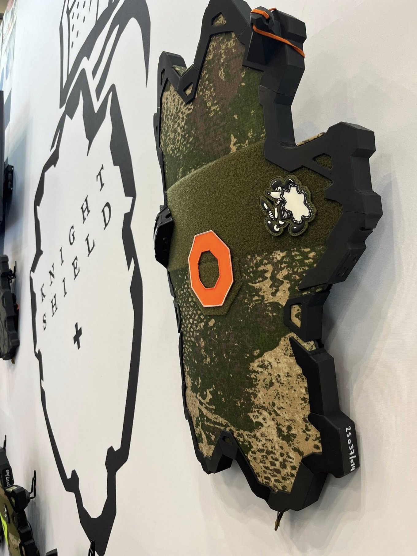 The same shield model in a different configuration, with a flashlight and camouflage
