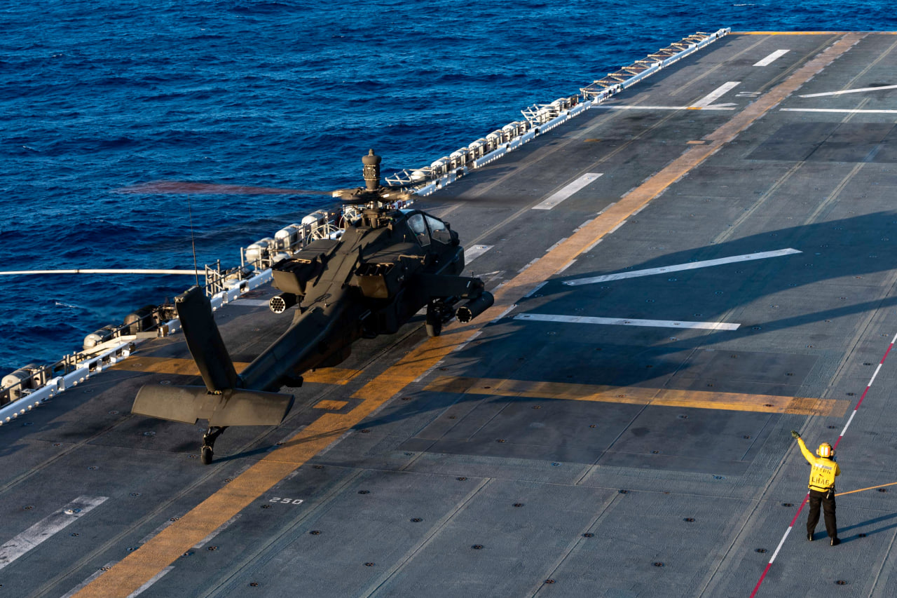 Attack helicopter AH-64E landing on the deck of the US Navy’s amphibious assault ship USS America (LHA 6)