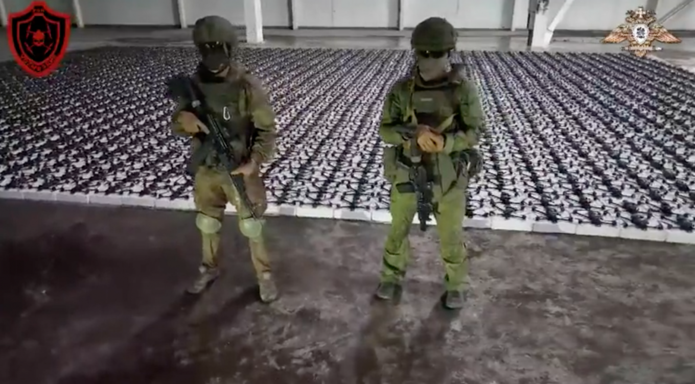 Russian soldiers standing in front of a new batch of camera copter drones