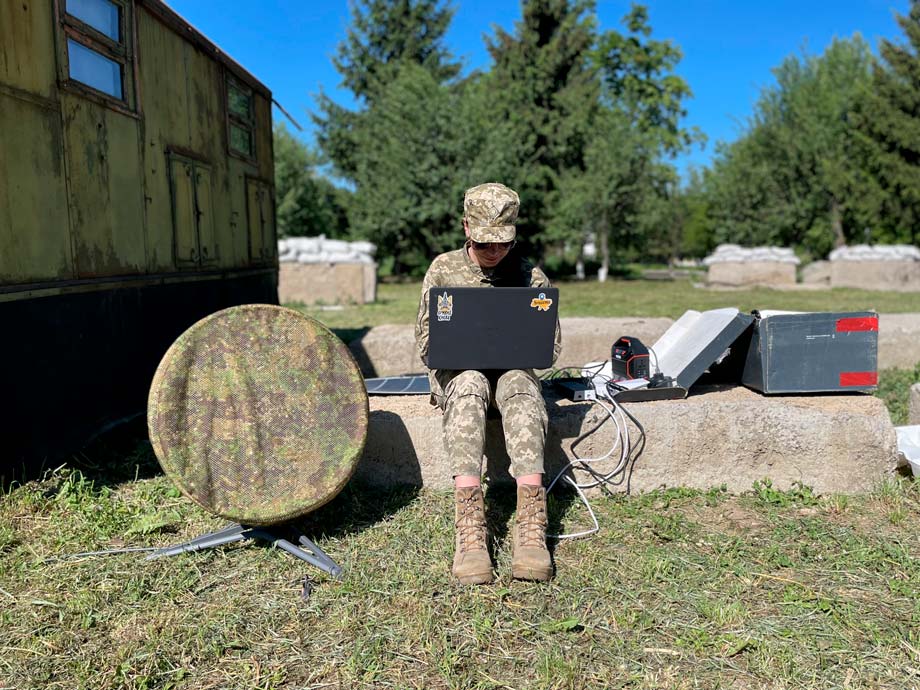 Ukrainian soldier next to a disguised Starlink antenna