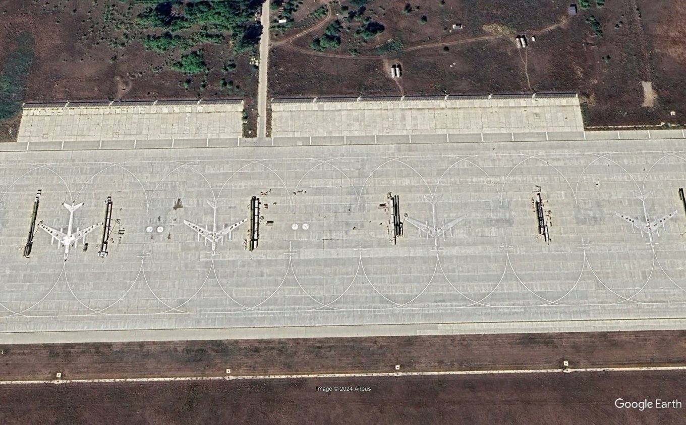 Aircraft paintings on a taxiway of the Engels airfield, August 2024 / Defense Express / Year Later, Pentagon Explains What's the Point of Aircraft Drawings and Tire Coatings at russian Military Airfields