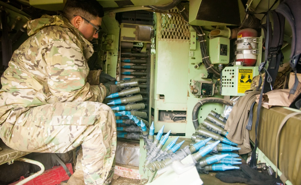 Illustrative photo: 25mm ammunition is loaded into a Bradley turret