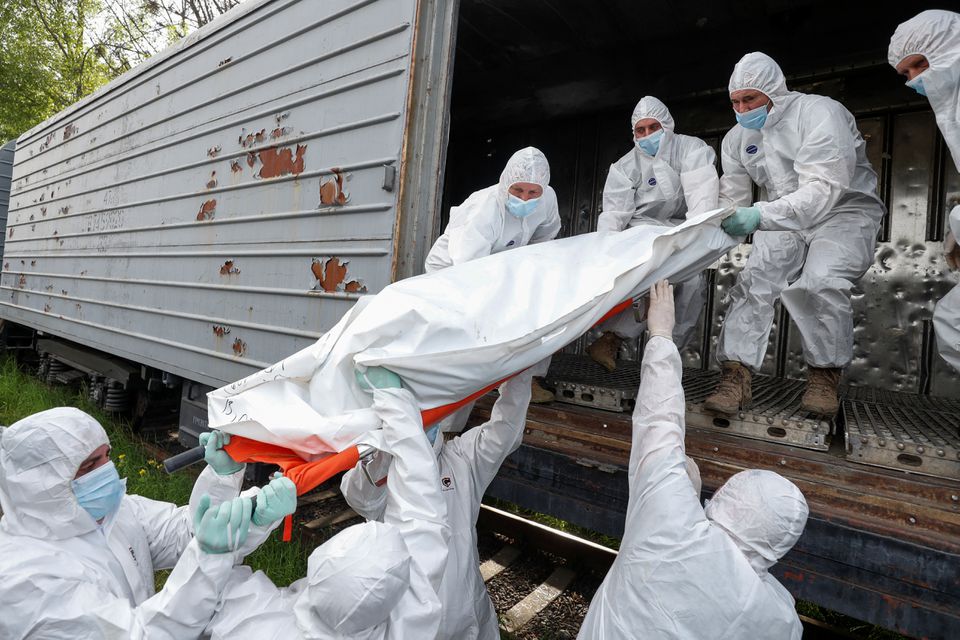 Ukrainian servicemen load a refrigerated rail car with bodies of Russian soldiers killed during Russia's invasion on Ukraine, in Kyiv, Ukraine May 13, 2022, Defense Express