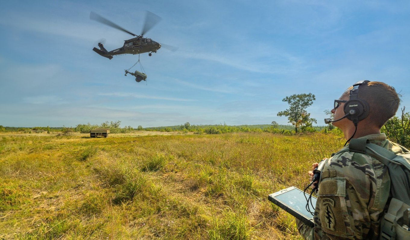 The U.S. Army National Guard Sergeant uses a tablet to command the Sikorsky OPV Black Hawk