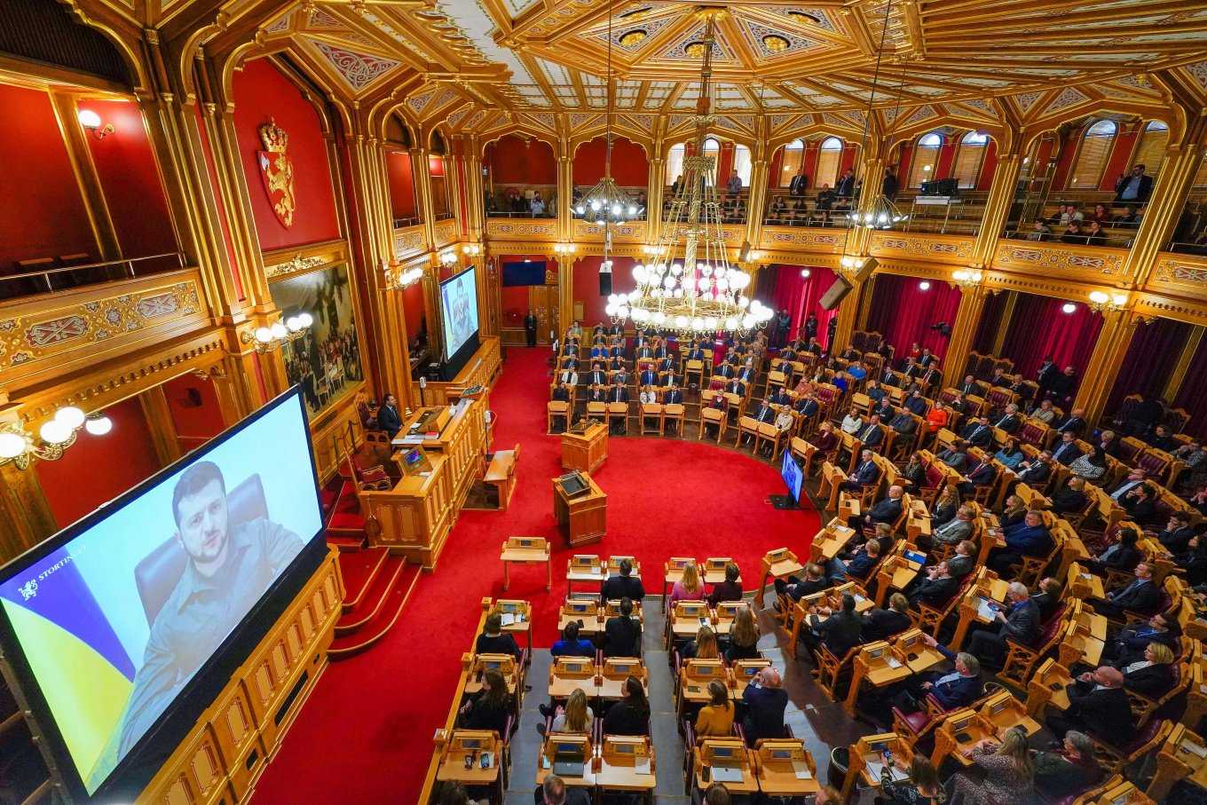 Ukrainian President Volodymyr Zelensky is seen on large screens as he addresses members of Norway's Parliament, The Storting, in Oslo, Norway, on March 30, Day 35th of Ukraine's Defense Against Russian Invasion, Defense Express