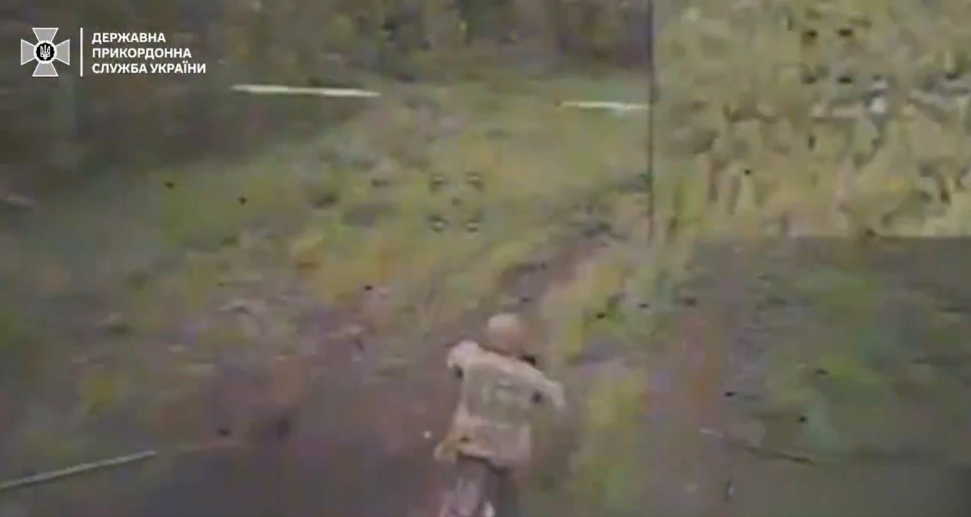 A russian stormtrooper on a motorcycle seconds before being destroyed by a Ukrainian drone