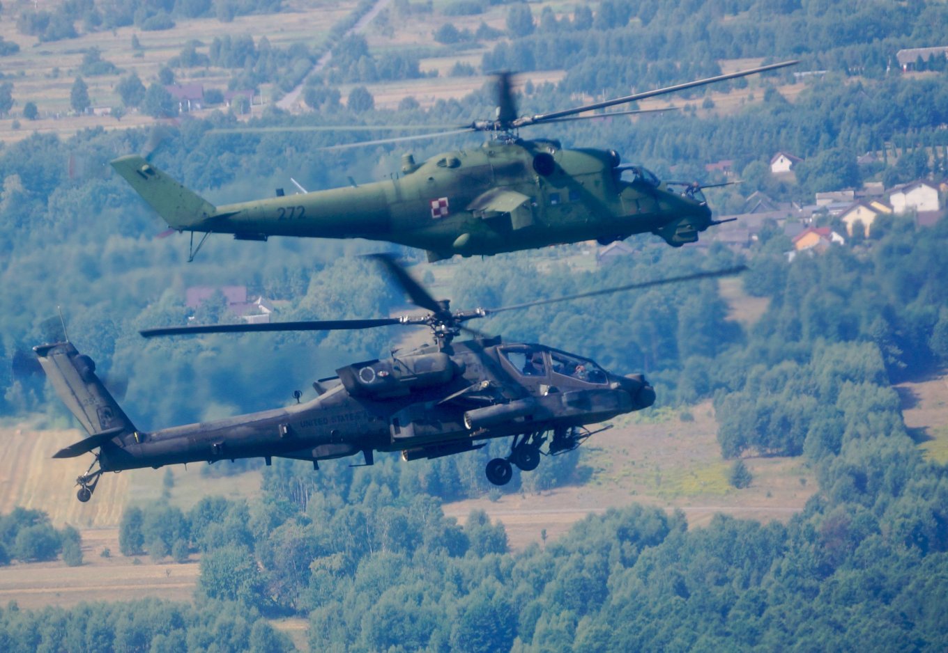 American AH-64E Apache next to a Polish Mi-24