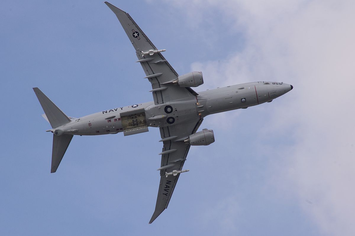 U.S. Navy P-8 Poseidon patrol aircraft with bomb hatches open and two UGM-84 