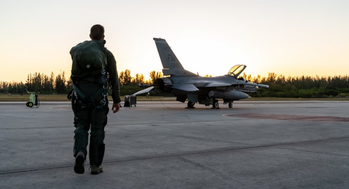 A pilot from the 93rd Fighter Squadron walks towards an F-16 Fighting Falcon