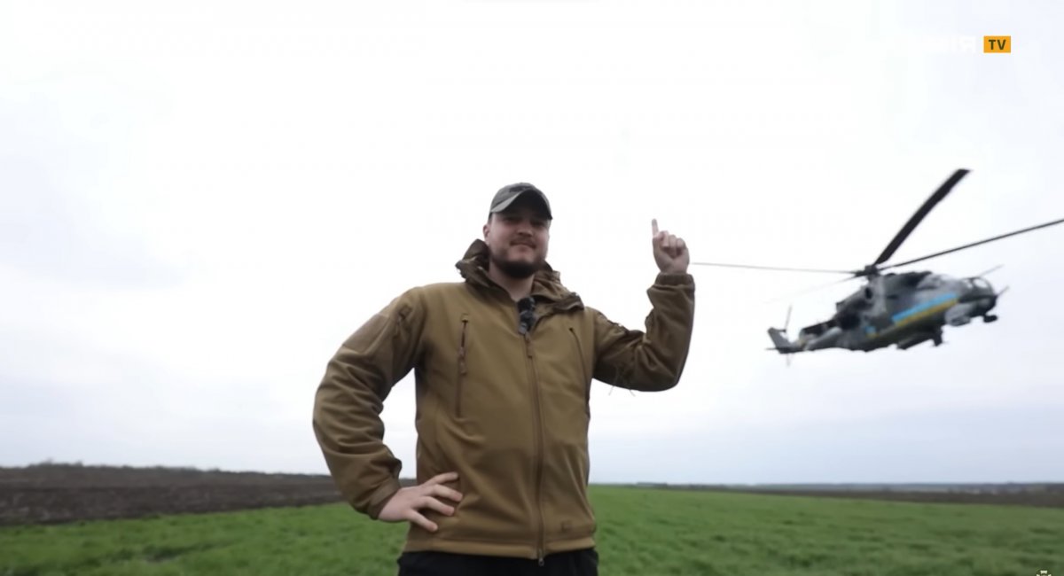 Army TV journalist, Major Oleh Dudka, against the Mi-24V helicopter flying by / Screenshot credit: Army TV