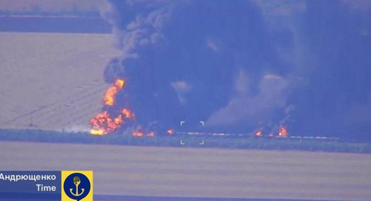 The derailed train burns after the Ukrainian strike (cropped) / Photo credit: Petro Andriushchenko on Telegram