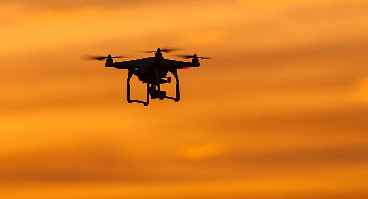 Small reconnaissance drone flying at sunset / Open-source photo