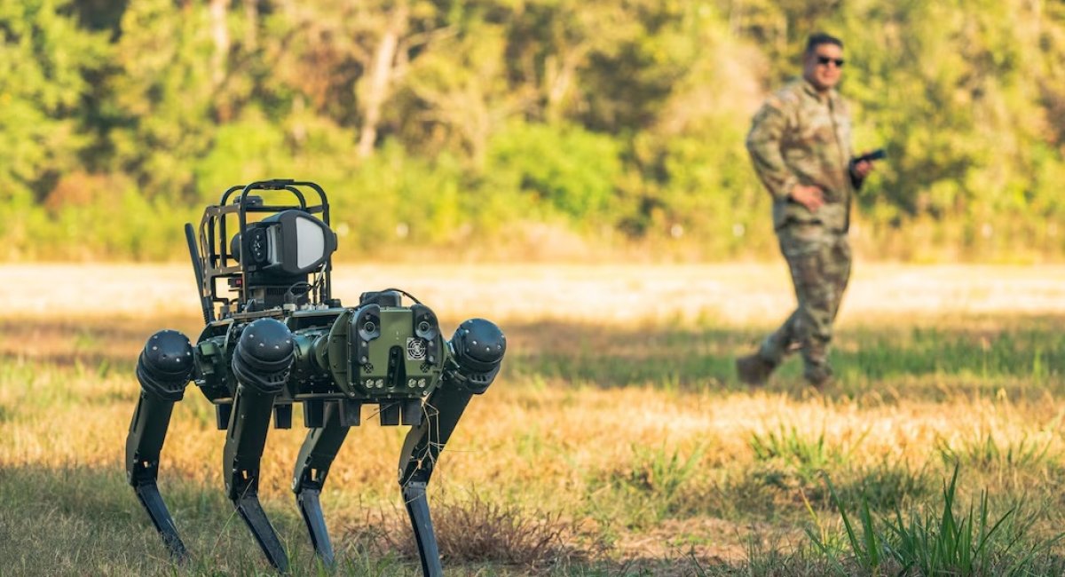 Air Force Master Sgt. Dominic Garcia observes Atom the robot dog as teammates operate it via remote control training / Photo credit: U.S. Department of War