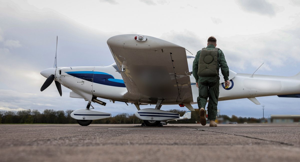 A Ukrainian pilot-in-training heading to a Grob Tutor trainer jet during basic training in preparation to master F-16 / Photo credit: UK Ministry of Defense