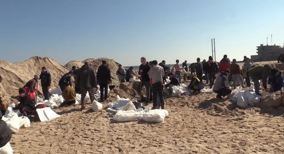 Screenshot image: civilian volunteers in Odesa fill the sacks with sand for the fortifications of their freedom-loving Southern city on the Black Sea shore / Image credit: TV and radio studio "Briz" ("Breeze") of the Ukrainian Defense Ministry