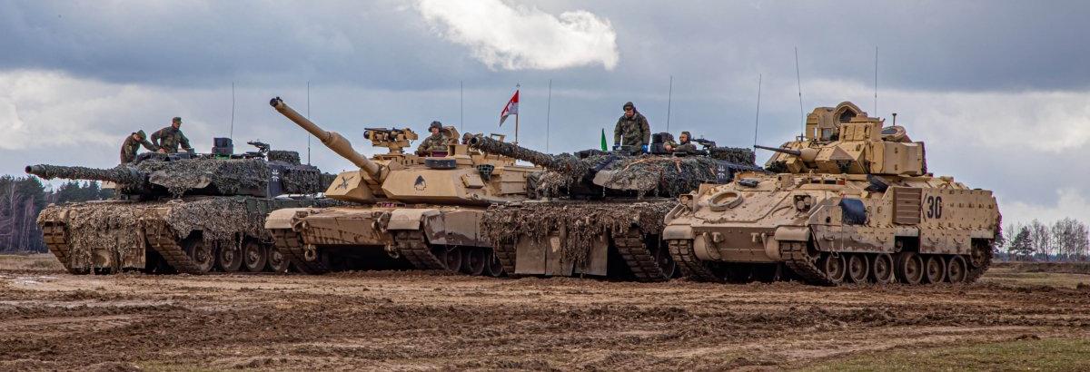 An M1A2 Abrams tank and M2 Bradley fighting vehicle next to German Leopard 2A6 tanks / Illustrative photo credit: U.S. Army National Guard
